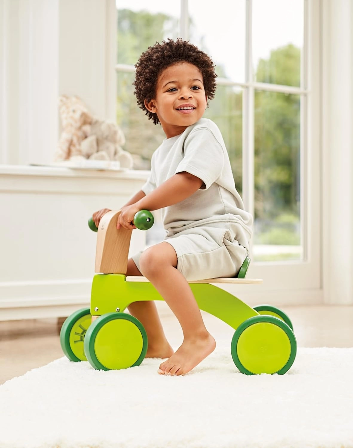 Hape Scoot Around Ride On Wood Bike | Award Winning Four Wheeled Wooden Push Balance Bike Toy for Toddlers with Rubberized Wheels, Bright Green