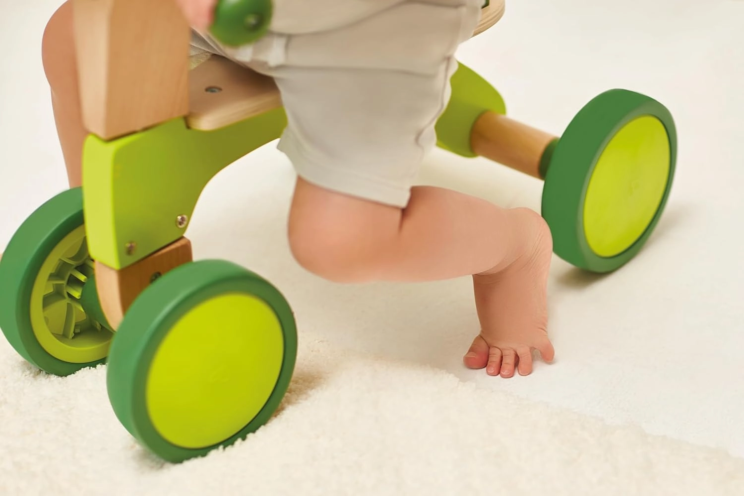 Hape Scoot Around Ride On Wood Bike | Award Winning Four Wheeled Wooden Push Balance Bike Toy for Toddlers with Rubberized Wheels, Bright Green